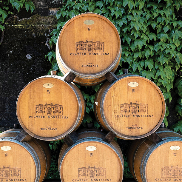 Stacked wine barrels in front of winery 